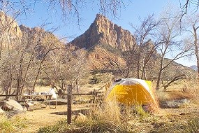 Yellow tent in a campsite.
