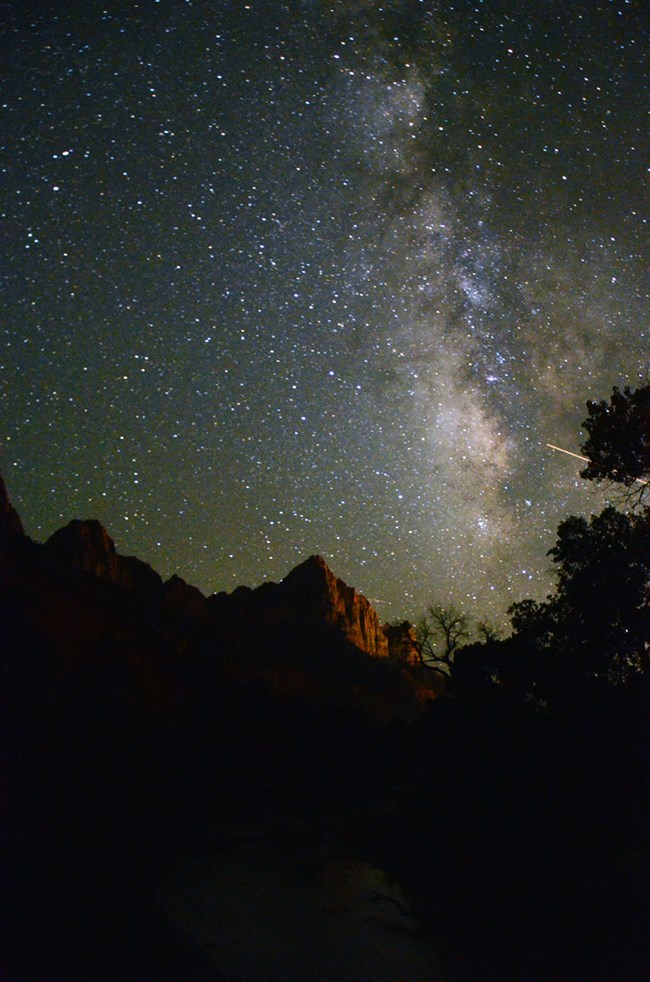 The Milky Way stretches over the Watchman.
