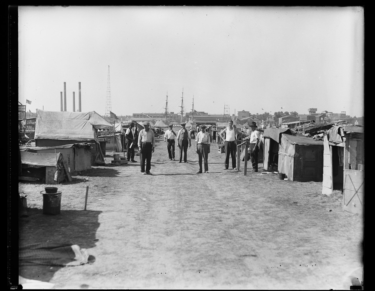 Seven men standing inside the Anacostia Bonus Army camp.