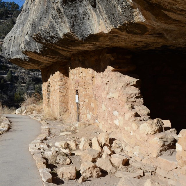 view of cliff dwelling along paved trail