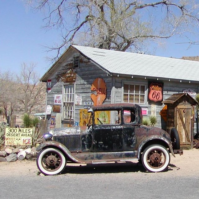 historic car in front of General Store next to road