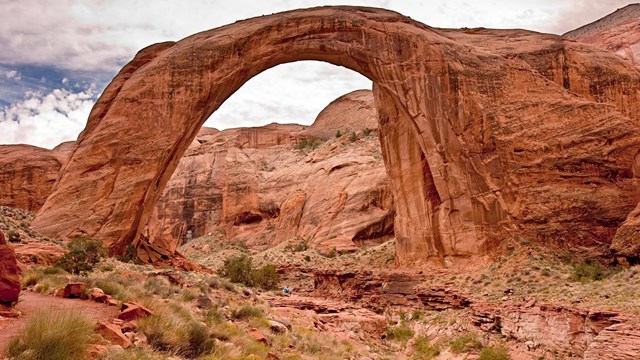 A large natural sandstone arch-shaped bridge.