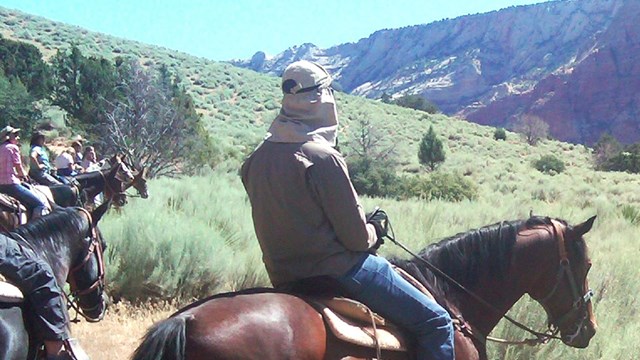 Visitors on horseback take in the scenery.