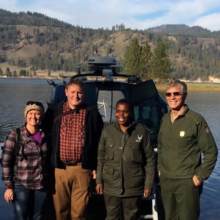 Tinyiko Golele, a park ranger from Kruger, stands with Lake Roosevelt Superintendent and friends.